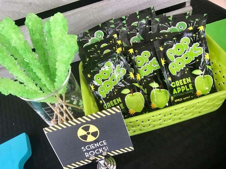 some green apples are in a basket on a table with a sign that says science rocks