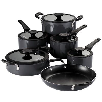 a set of black pots and pans with lids