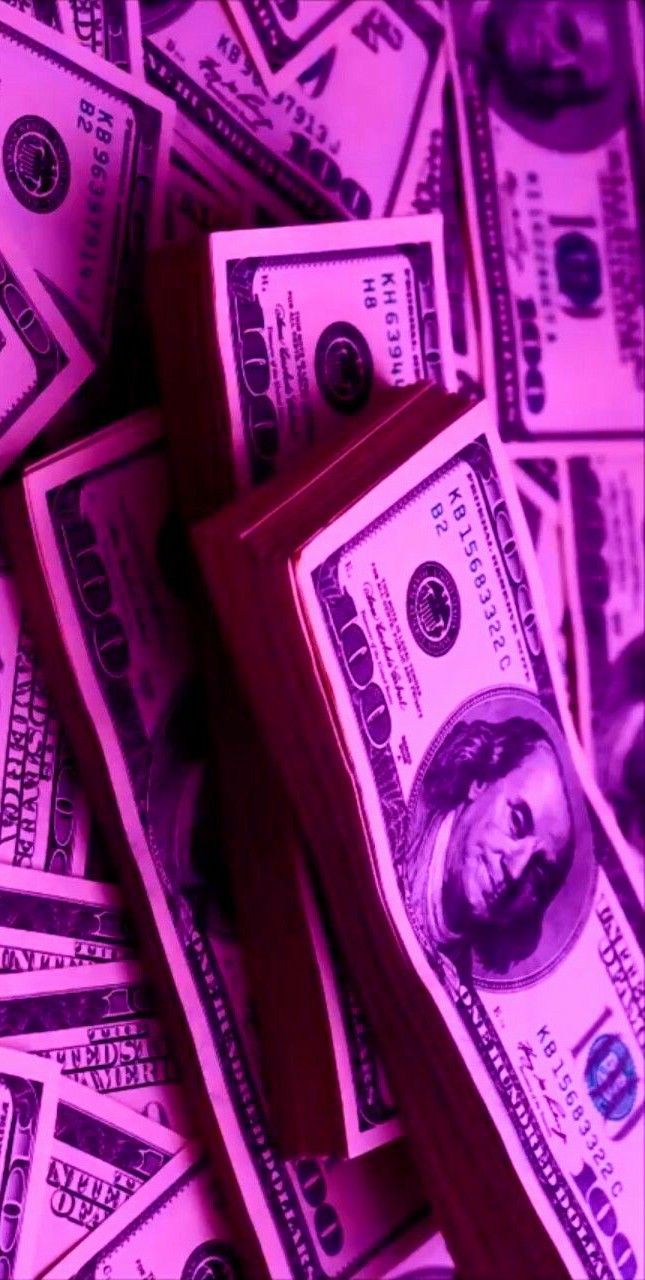 a pile of money sitting on top of a purple table covered in lots of dollars