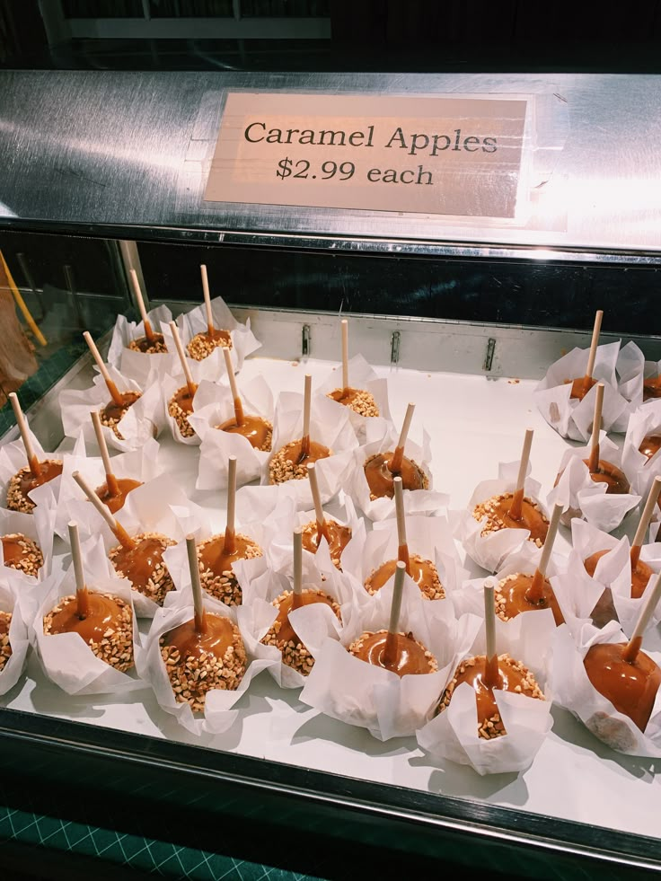 caramel apples are arranged on skewers with toothpicks