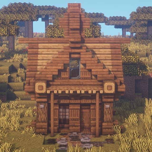 a wooden house in the middle of a field