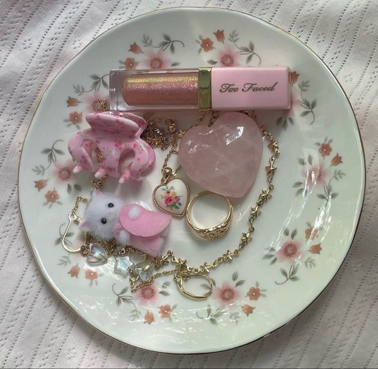 a white plate topped with assorted items on top of a pink flowered table cloth