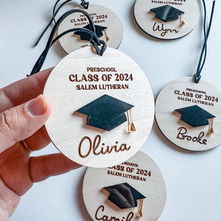 four personalized wooden graduation ornament with tassels