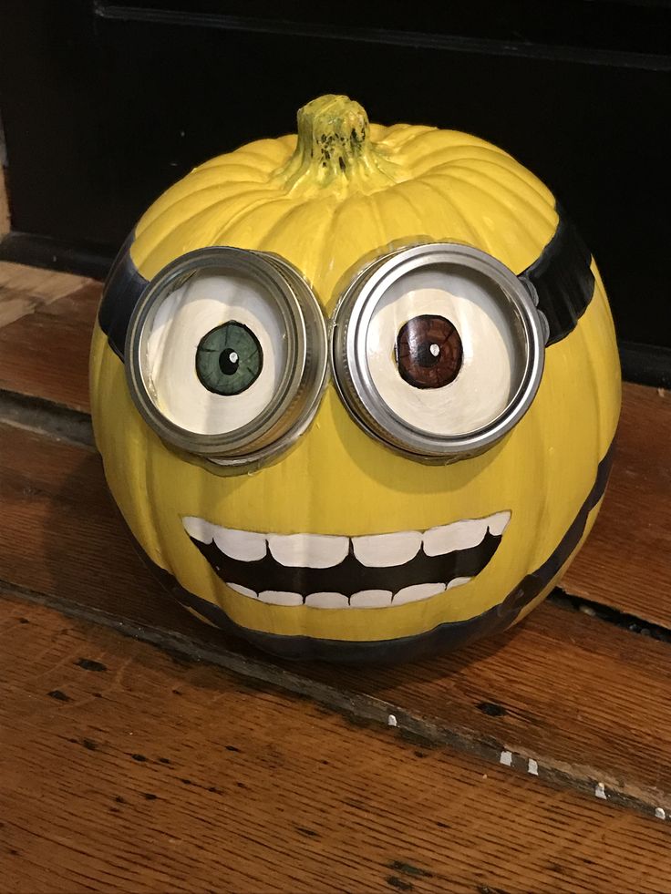 a yellow pumpkin with googly eyes on it