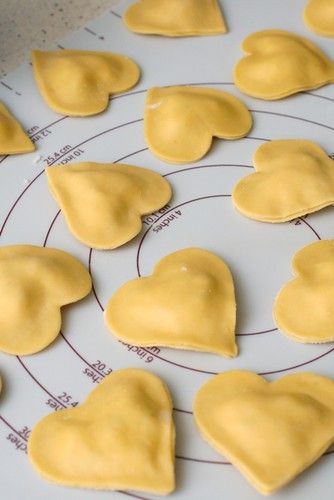 heart shaped cookies on a cookie sheet ready to be cut into hearts for valentine's day