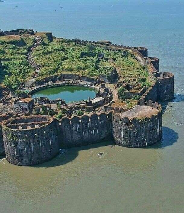 an aerial view of a castle in the water