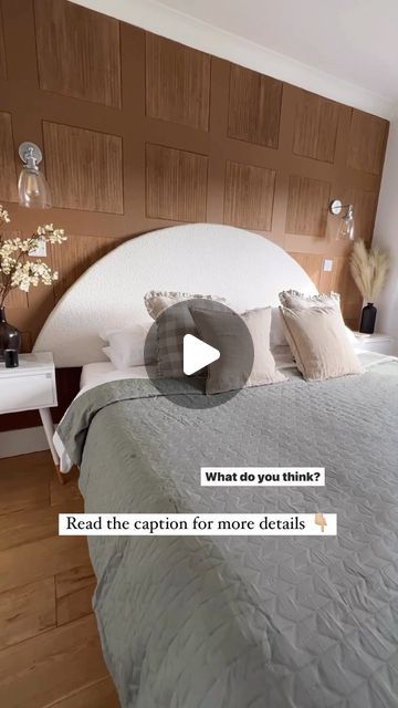 a bed room with a neatly made bed and wooden paneling on the wall behind it