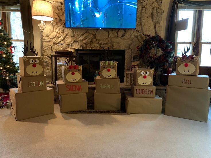 several boxes with reindeer faces on them sitting in front of a television