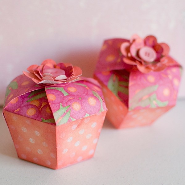 two small pink boxes with flowers on them