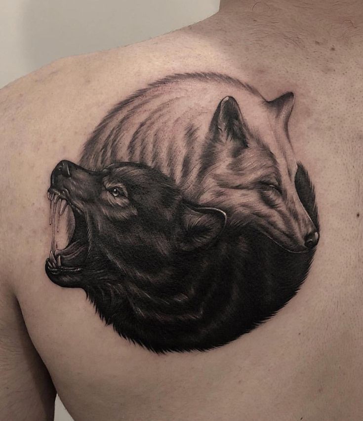 a man's chest with two foxes on it and one is biting at the other