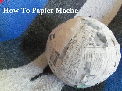 an old paper mache sitting on top of a blue and white striped rug with the words how to paper mache