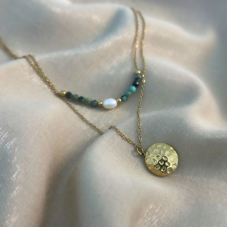 This beautiful piece features turquoise beads, a natural shell and a honeycomb-shaped 18k gold-plated pendant. It's the perfect accessory to add a touch of spirituality and style to any outfit. The turquoise beads are said to represent wisdom, protection and good fortune, while the natural shell is a symbol of strength, stability and new beginnings. The honeycomb pendant is a reminder that sweetness can be found in the simplest things in life. Whether you're treating yourself or someone special, Spiritual Gold Jade Beaded Necklaces, Spiritual Gold Jade Beaded Necklace, Handmade Gold Amazonite Necklaces, Handmade Gold Amazonite Necklace, Gold Bohemian Necklace With Amazonite, Gold Bohemian Amazonite Necklace, Gold Turquoise Necklace With Round Beads For Gift, Gold Turquoise Necklace With Round Beads As A Gift, Turquoise Beaded Necklace With Pearl Charm As Gift