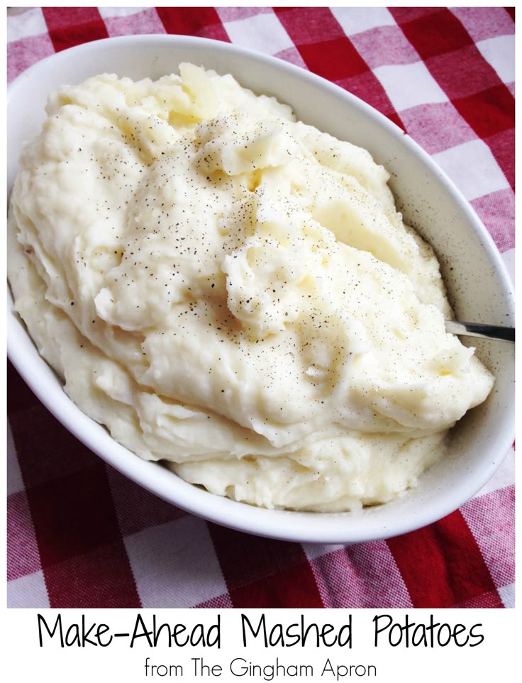 mashed potatoes in a white bowl on a red and white checkered tablecloth