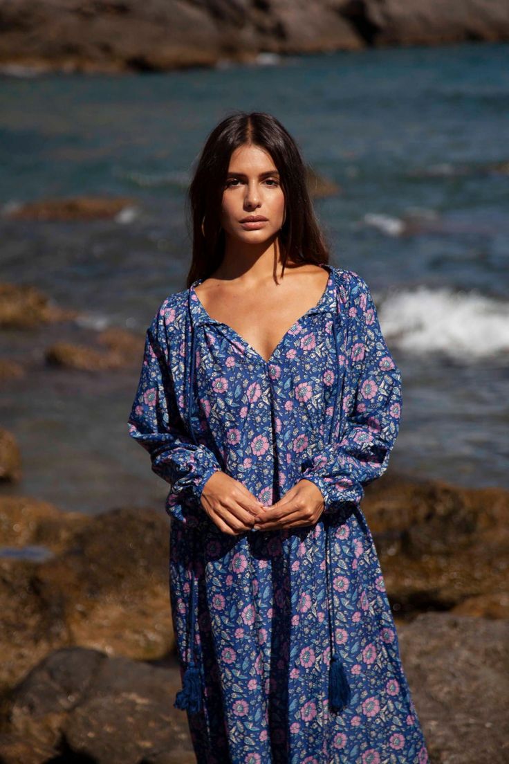 The Bella kaftan is made of light cotton silk voile and printed with vibrant florals. It has a lightweight, airy silhouette with long sleeves, button closure, and a tassel detail. This bohemian kaftan is the epitome of boho-chic style and is as elegant as it is comfortable.Wear yours with flat sandals and a woven tote. Long Sleeve Dresses With Blouson Sleeves For Vacation, Vacation Long Sleeve Dress With Blouson Sleeves, Bohemian Tunic Kaftan For Daywear, Bohemian Tunic Kaftan, Bohemian Flowy Dress With Blouson Sleeves, Bohemian Long Sleeve Boho Dress With Floral Print, Long Sleeve Bohemian Dress With Floral Print, Long Sleeve Bohemian Boho Dress With Floral Print, Bohemian Summer Dresses With Blouson Sleeves