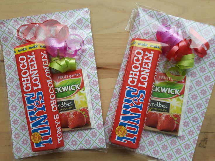 two packages of candy sitting on top of a wooden table