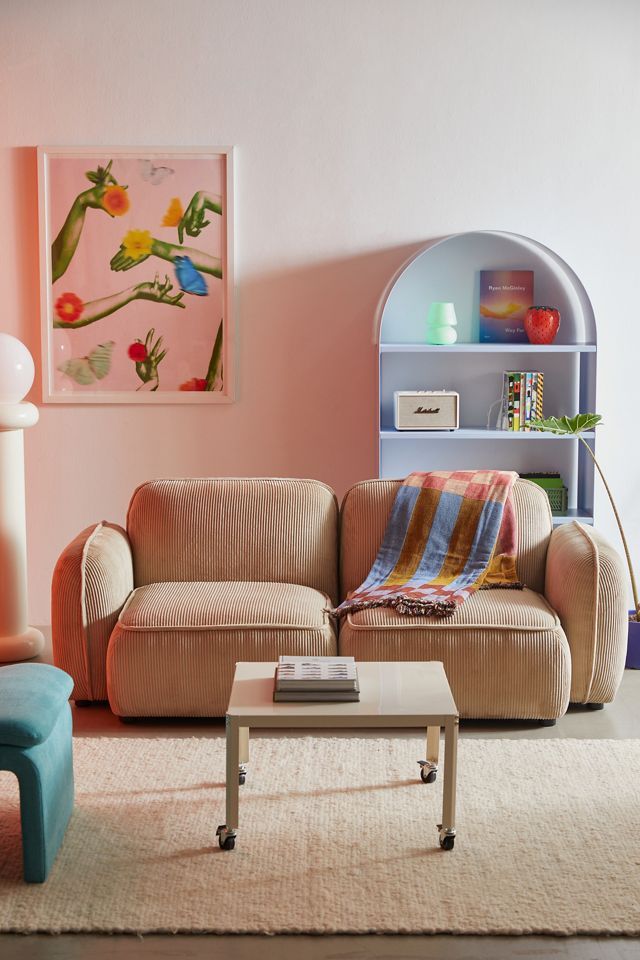 a living room filled with furniture and a book shelf