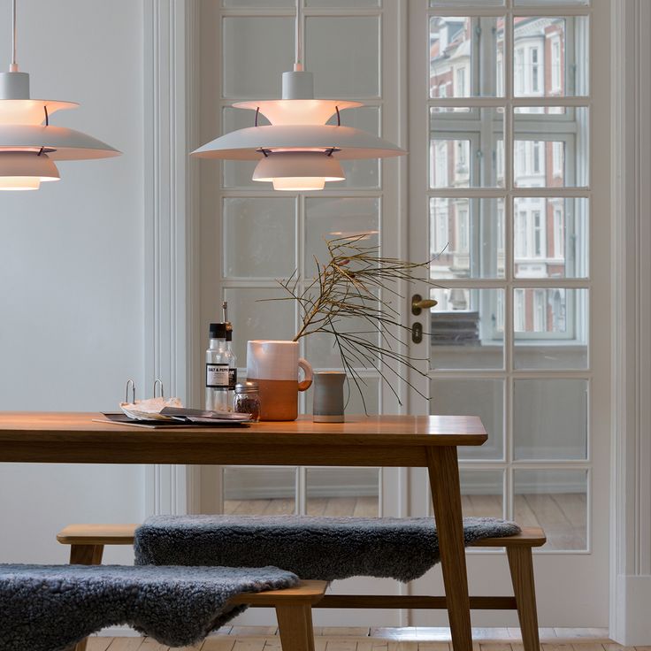 an image of a dining room setting with modern lighting