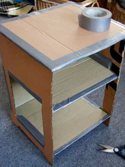 a table that is being constructed with cardboard and plywood