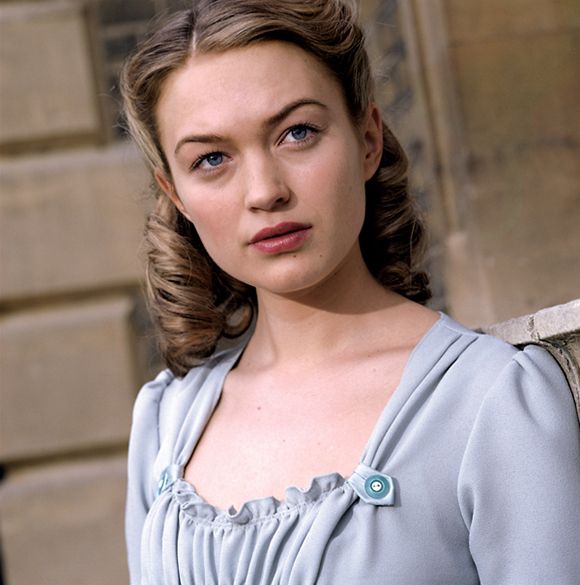 a woman in a blue dress posing for the camera