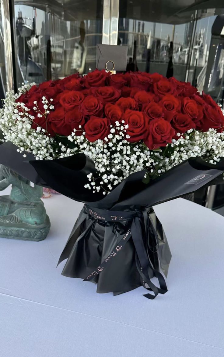 a bouquet of red roses sitting on top of a table