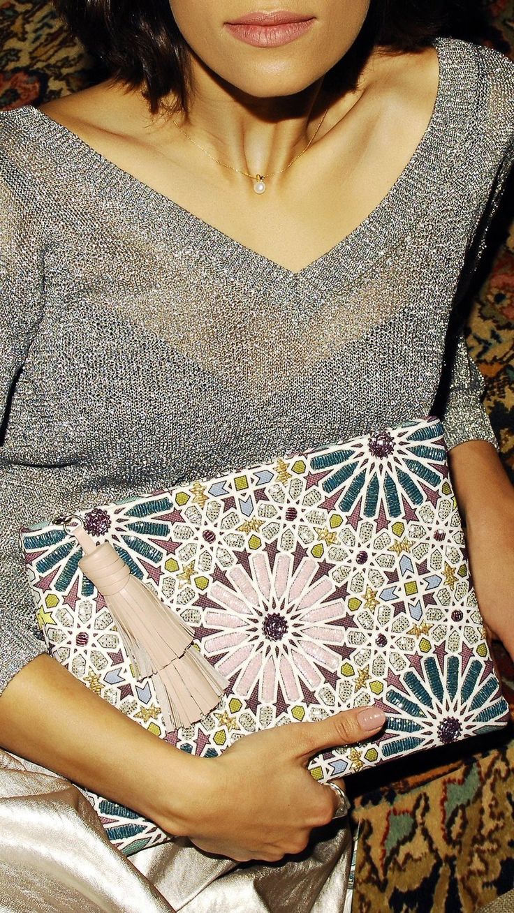 Sarah’s Bag Moroccan Pouch in Pastel Complement your daytime or chic jeans edit with this elegant piece that pays homage to the Islamic art of zelij, an exquisite form of mosaic tile work that can be seen in all its splendor across Morocco. This zippered pouch is meticulously hand beaded with an intricate zelij pattern in bright sunny colors and is finished with a leather tassel. Purchase Worn by Princess Catharina-Amalia on:8 February 2023 Chic Jeans, Jeans Look, Statement Bag, Tile Work, Zippered Pouch, Leather Tassel, Mosaic Tile, Blue Tones, Pink Leather