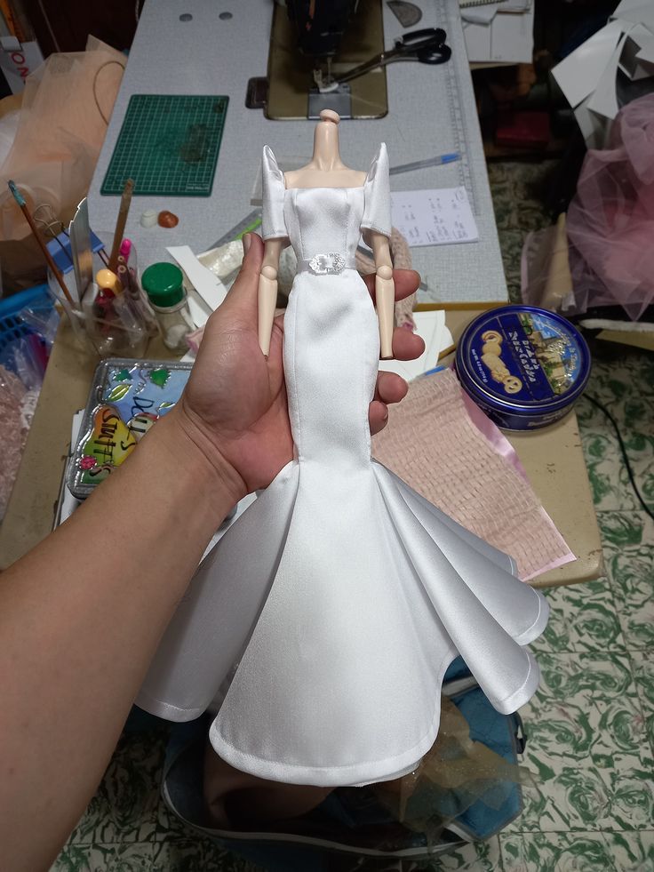 someone is making a wedding dress out of paper machs on a sewing machine table