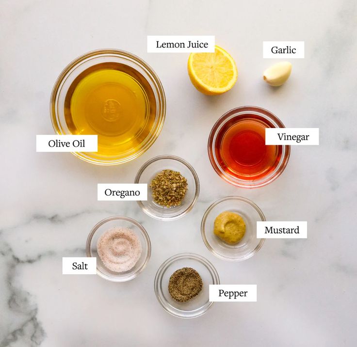 the ingredients to make an apple cider recipe on a marble countertop with labels