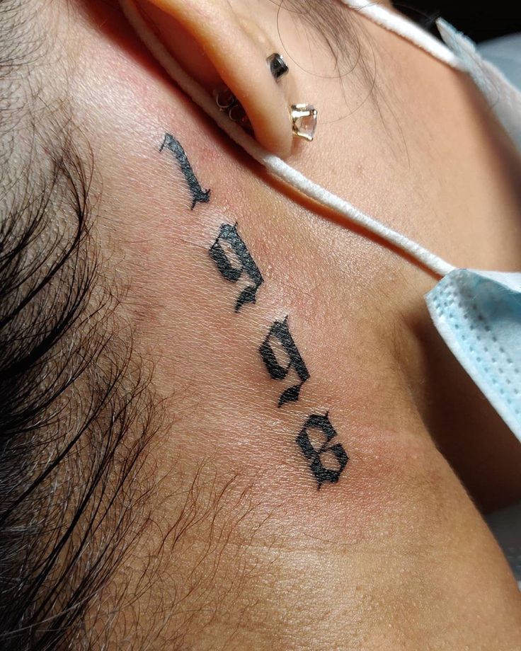 a man's neck with the word tattoo on it