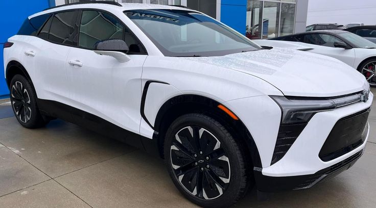 a white suv parked in front of a building