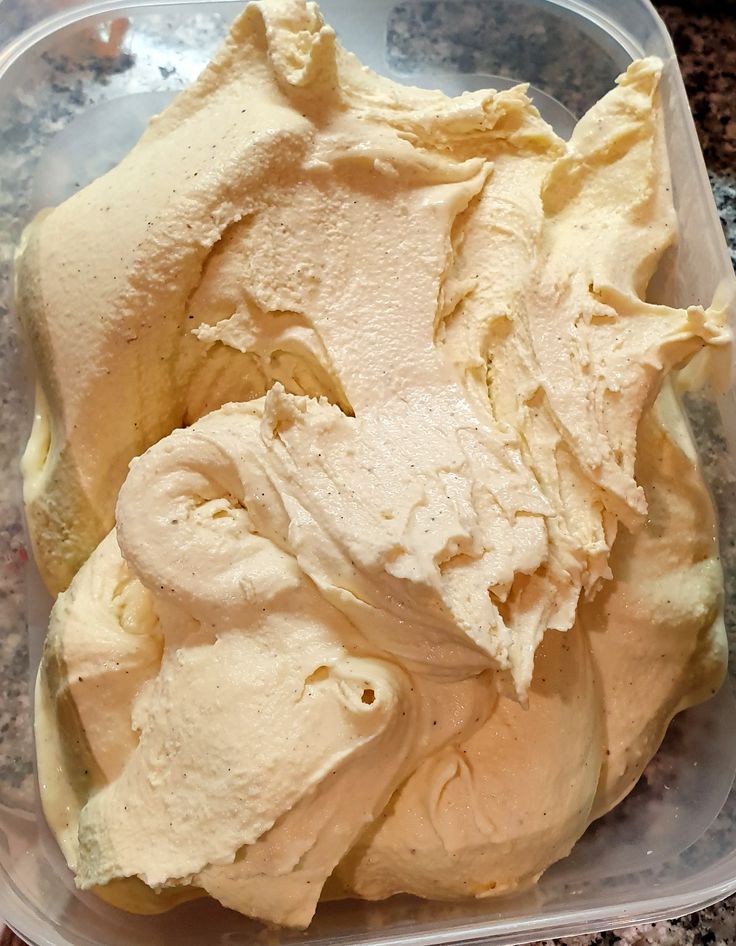 a plastic container filled with ice cream on top of a counter