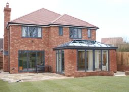 a large brick house with glass doors and windows