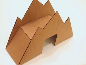 an origami house made out of cardboard