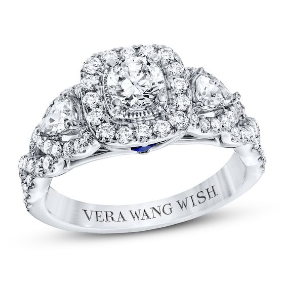 a white gold ring with three pear shaped diamonds on the band and an inscription vera wang love