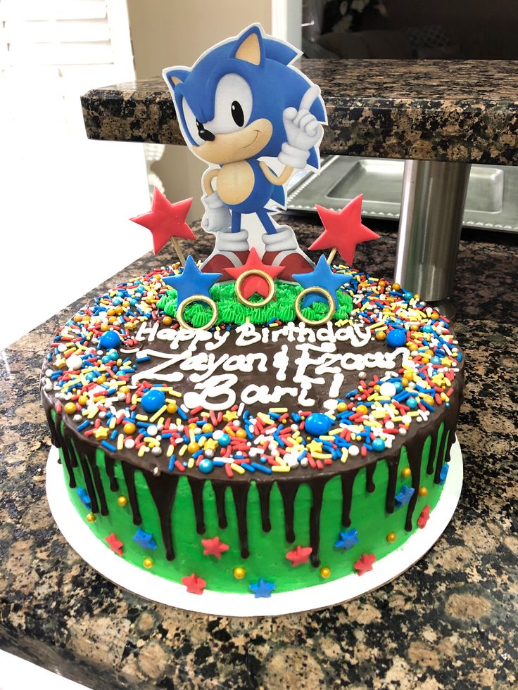 a birthday cake decorated with sprinkles and an image of sonic the hedgehog