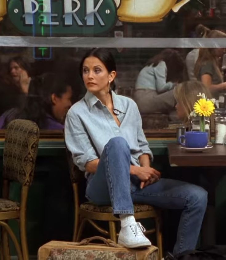 two people sitting at a table in front of a sign with the words perk on it