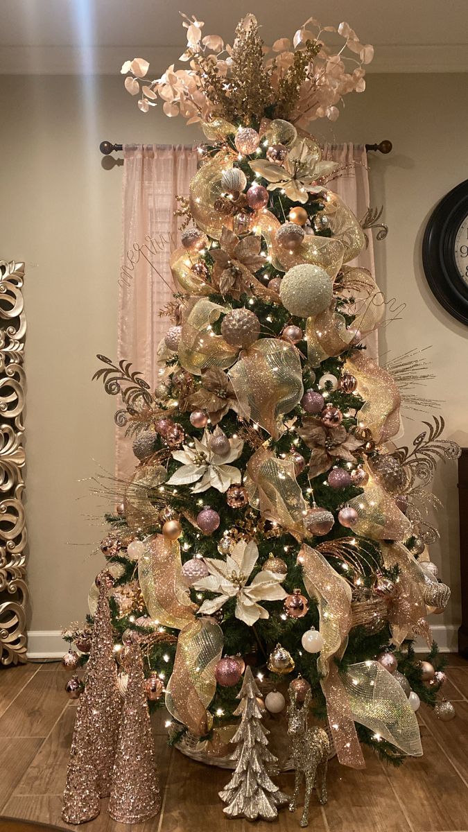 a christmas tree decorated with gold and silver ornaments