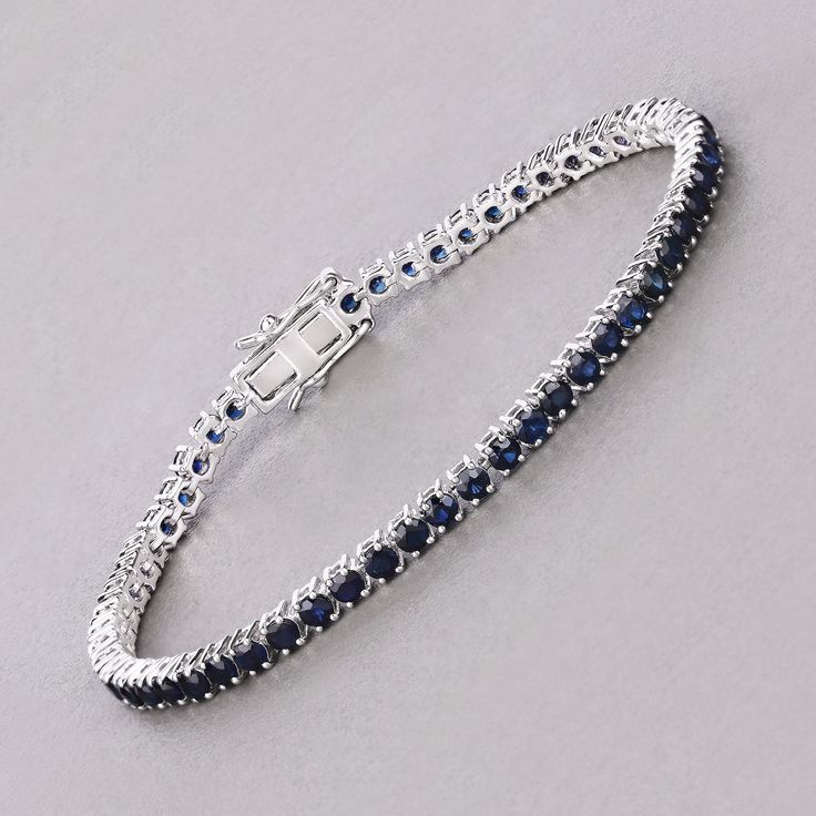 14k Gold Blue Sapphire Bracelet, Genuine Blue Sapphire Rounds Gold Bracelet for Women, Blue Sapphire Gold Tennis Bracelet, Gift for Her Dazzle in the deep blue allure of this 14K white gold tennis bracelet, featuring 6.38 carats of genuine round blue sapphires. Each sapphire is meticulously set to create a seamless line of vibrant color, perfect for adding a touch of luxury to any ensemble. The bracelet's classic design is enhanced by its secure box clasp, ensuring both elegance and peace of min Round Sapphire Bracelet, Luxury Sapphire Round Bracelets, Fine Jewelry Sapphire Bracelets, Sapphire Tennis Bracelet Fine Jewelry With Prong Setting, Blue Tennis Bracelet With Prong Setting For Formal Occasions, Classic Blue Diamond Bracelet In Sterling Silver, Formal Sapphire Tennis Bracelet In Fine Jewelry Style, Elegant Blue Diamond Bracelet With Prong Setting, Classic Blue Sterling Silver Diamond Bracelet