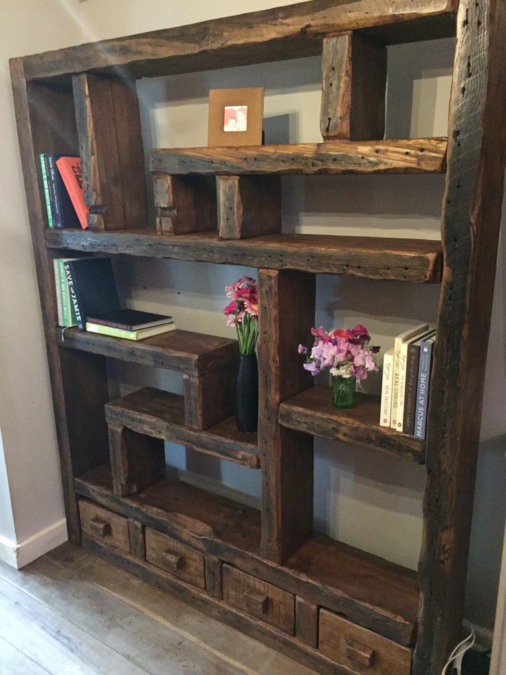 an old wooden bookcase with drawers and flowers