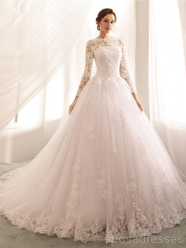 a woman in a white wedding dress standing next to a window with sheer drapes