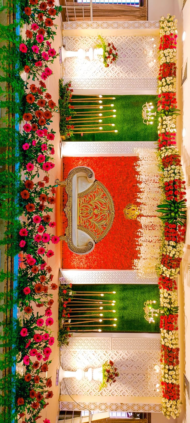 an overhead view of a decorated hall with flowers and greenery on the ceiling,