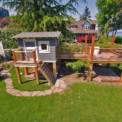 an aerial view of a backyard with steps leading up to a shed and deck area