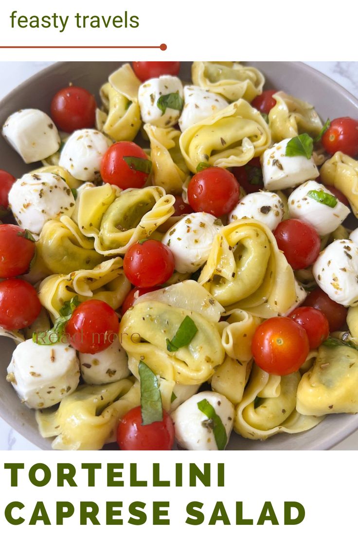 a bowl filled with pasta and cherry tomatoes