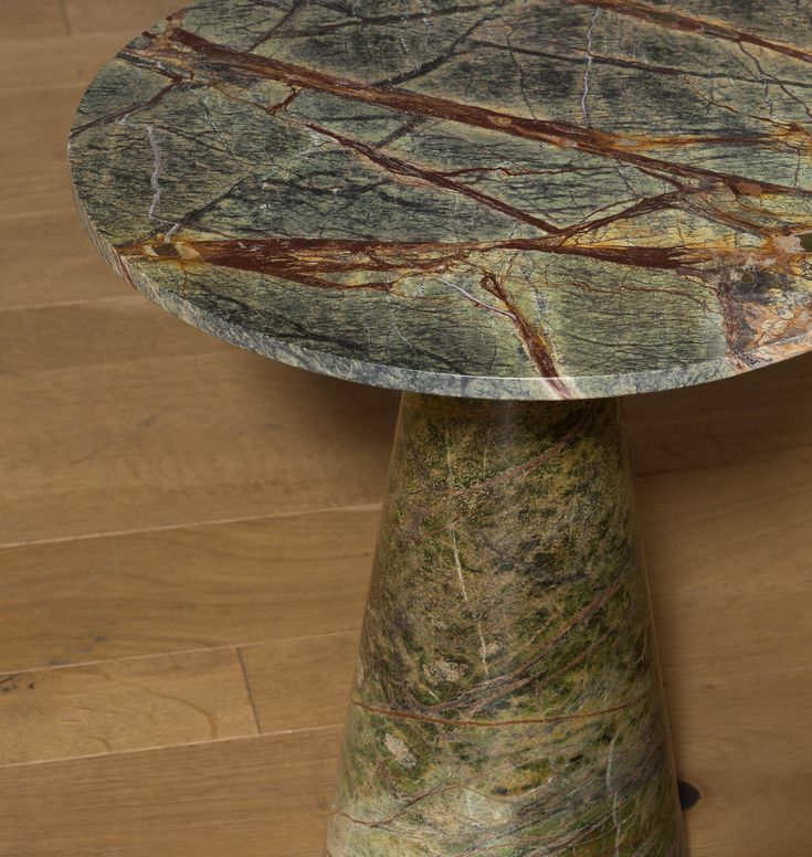 a marbled table sitting on top of a hard wood floor