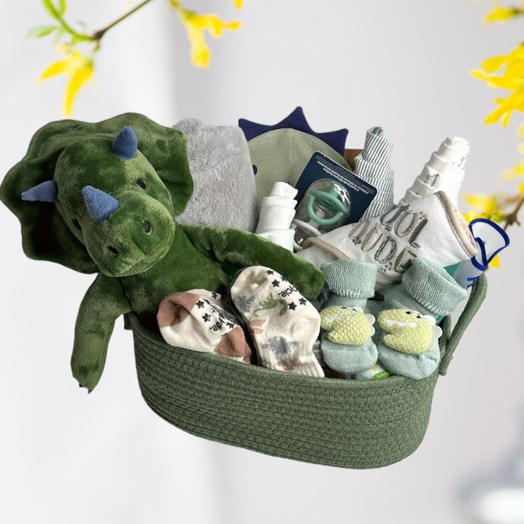 a green basket filled with lots of baby items