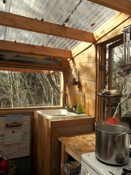 a kitchen with a stove top oven next to a window