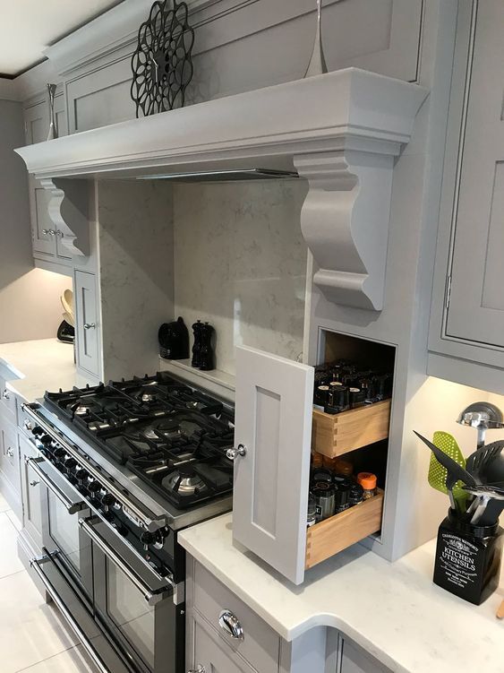 a kitchen with an oven, stove and cabinets in the middle of it's counter space