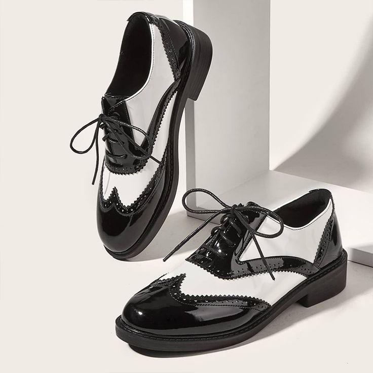 Step into sophistication with our Black White Patent Leather Oxfords. Featuring a classic round toe and lace-up design, these sleek oxfords blend timeless style with modern elegance. Color: Black and white Material: Patent leather Heel Type: Chunky heel Heel Height: 1.57'' / 40 mm approx Product measurements were taken using size 8. Please note that measurements may vary by size. Toe: Round toe Lace-up closure Colorblock design Wingtip shoe design Perforated details Handcrafted US sizing. Fits t Oxford Shoes Outfit Women's, White Oxford Shoes, Lace Up Loafers, Tuxedo Shoes, Oxford Shoes Outfit, Patent Leather Oxfords, Patent Loafers, Wingtip Shoes, Black And White Shoes