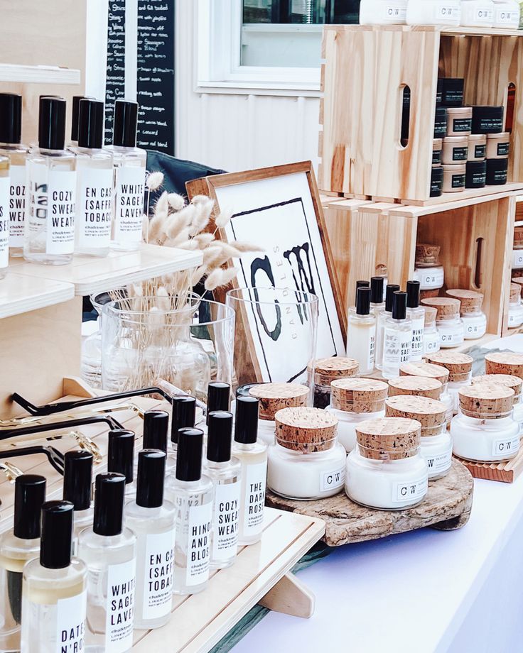 an assortment of skin care products on display in a store with wooden crates behind them