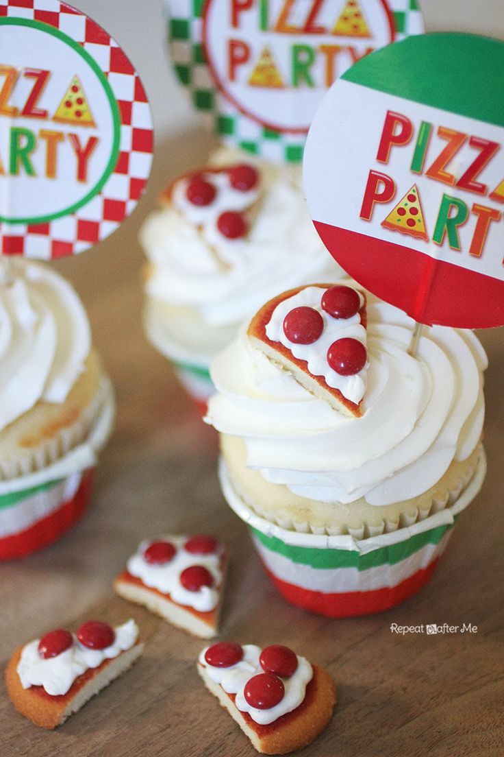 cupcakes with white frosting and red cherries are arranged on a table