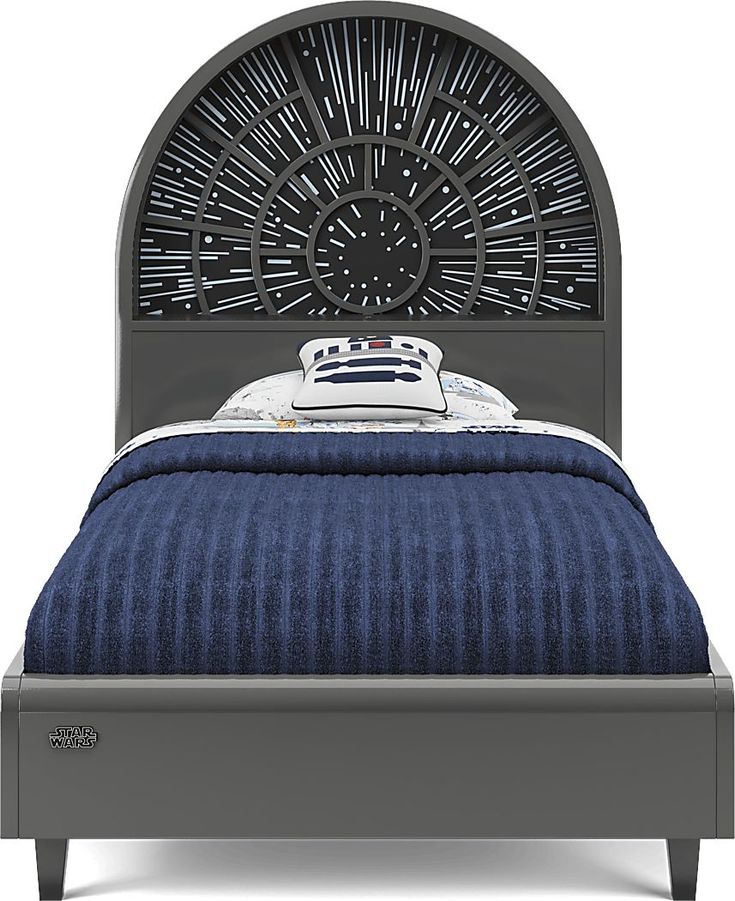 a bed with an iron headboard and blue bedspread